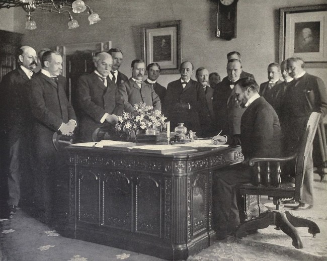 US Secretary of State John Hay signs the Treaty of Paris, ratified in 1899, which ended the Spanish–American Way and gave the US control of the Phillippines Source: Wikimedia Commons at https://tinyurl.com/288hp2c8.