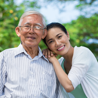Father and daughter smile at camera