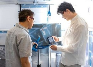 Researchers examine the IAQ devices at a UBCO lab. Image Credit: Darren Hull